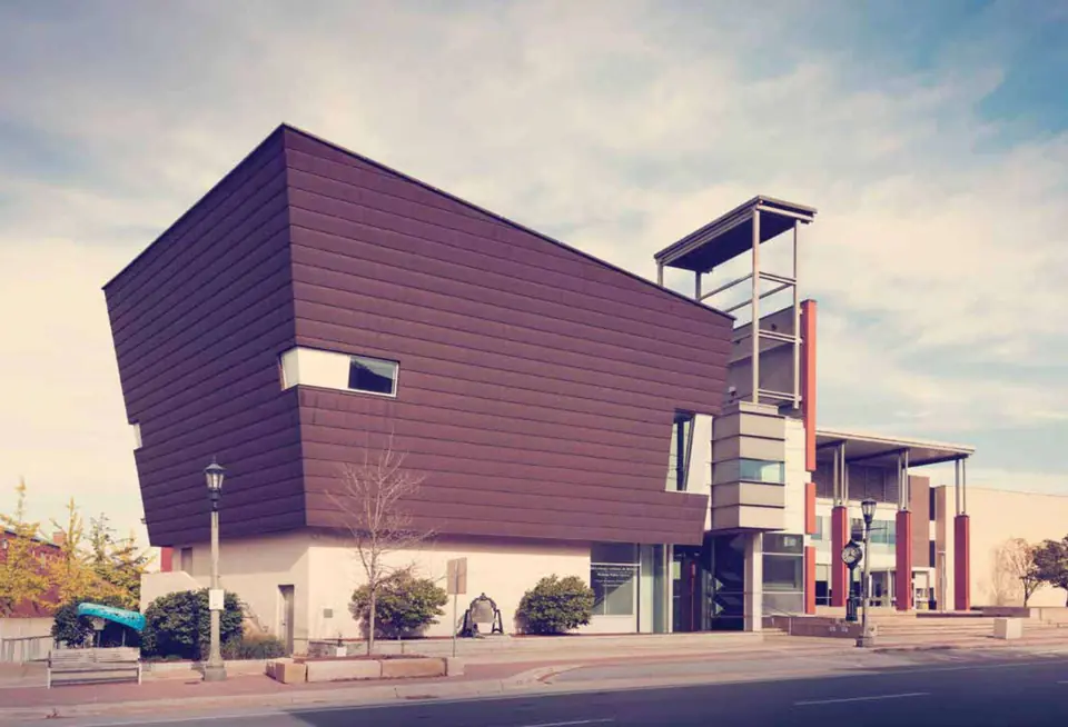 Angular building clad in plum architectural metal