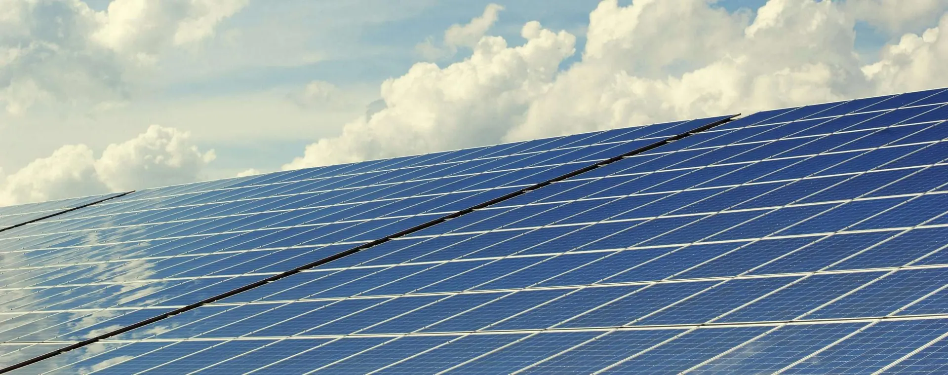 Solar panels against a bright sky