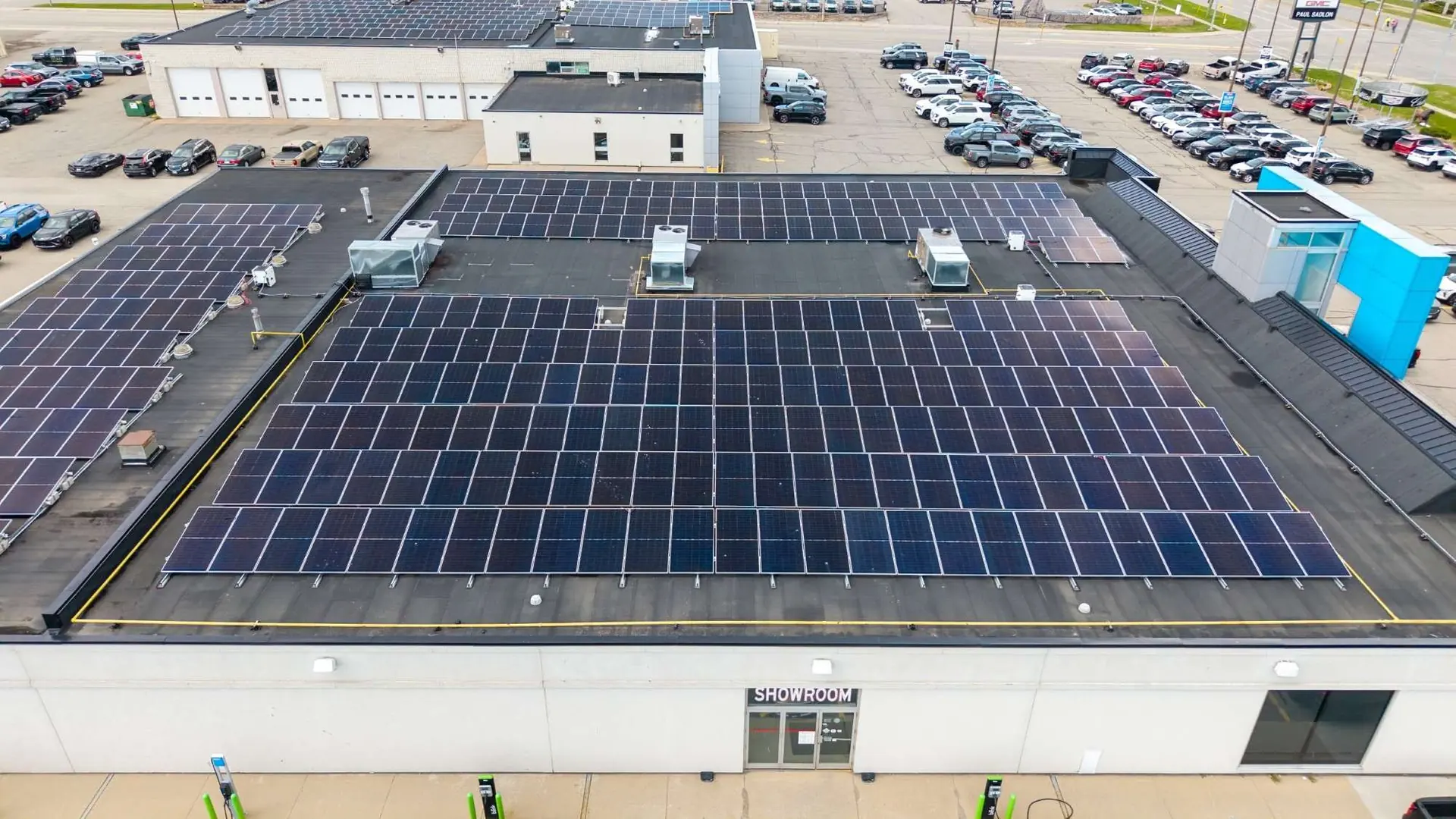 Aerial view of a commercial rooftop solar array above a parking lot
