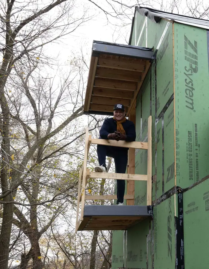 Crew working on the front elevation from scaffolding